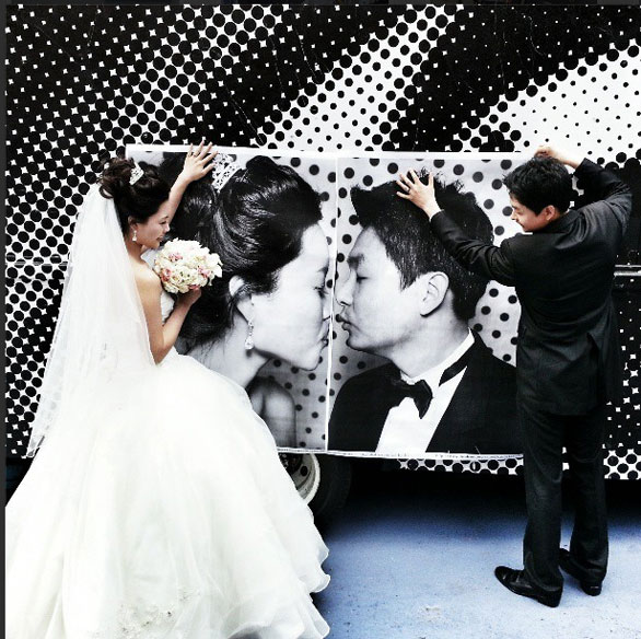 A bride and groom make their portraits kiss at the INSIDE OUT photo truck. Image: Instagram/JR