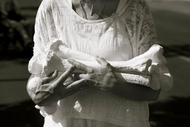 Participant carrying bones for a bone laying installation. Photo: Joanne Teasdale