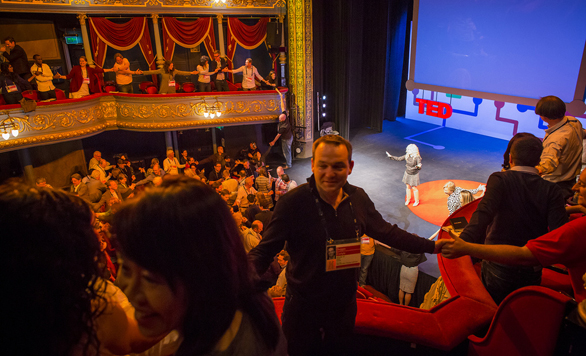The TED University audience plays a massive game of thumb wrestling. Photo: Ryan Lash