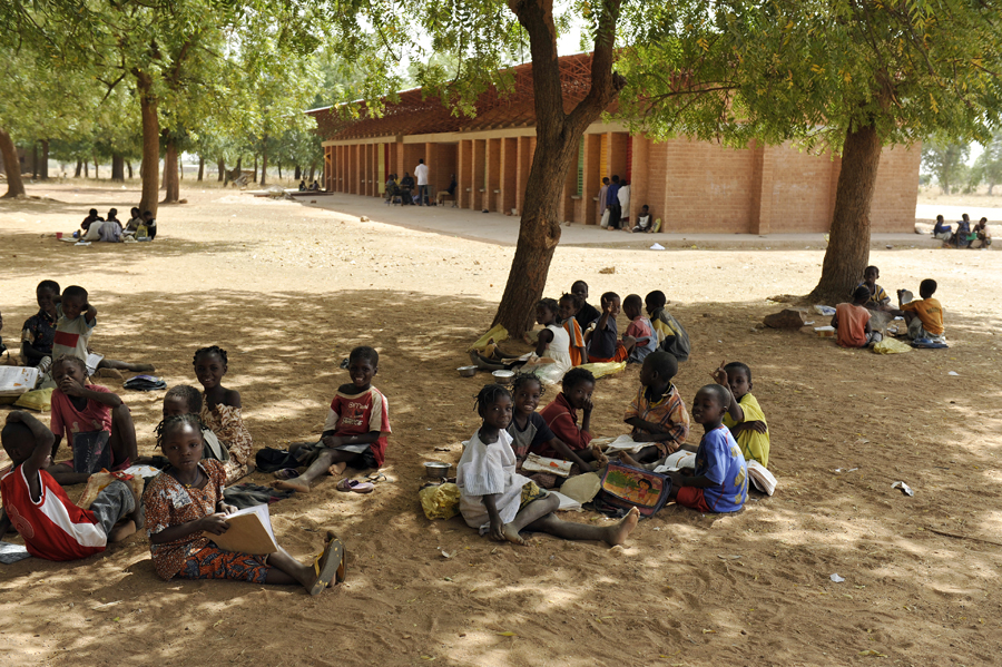 A group of children takes a break under a mango tree outside the Gando school extension. Photo: Erik-Jan Ouwerkerk