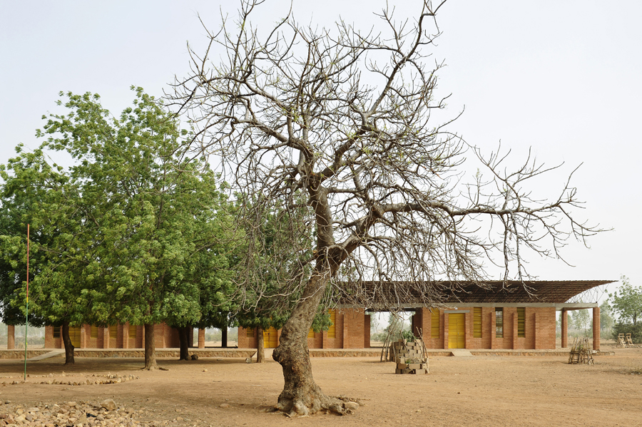 Kéré designed a primary school for Gando in 1999 and, with the help of residents of the village, construction was completed in 2001. The school’s walls are made from compressed clay, and the ceiling is made of corrugated metal on a steel truss to let air flow in freely. It has three classrooms, separated by shaded outdoor spaces. Photo: Erik-Jan Ouwerkerk