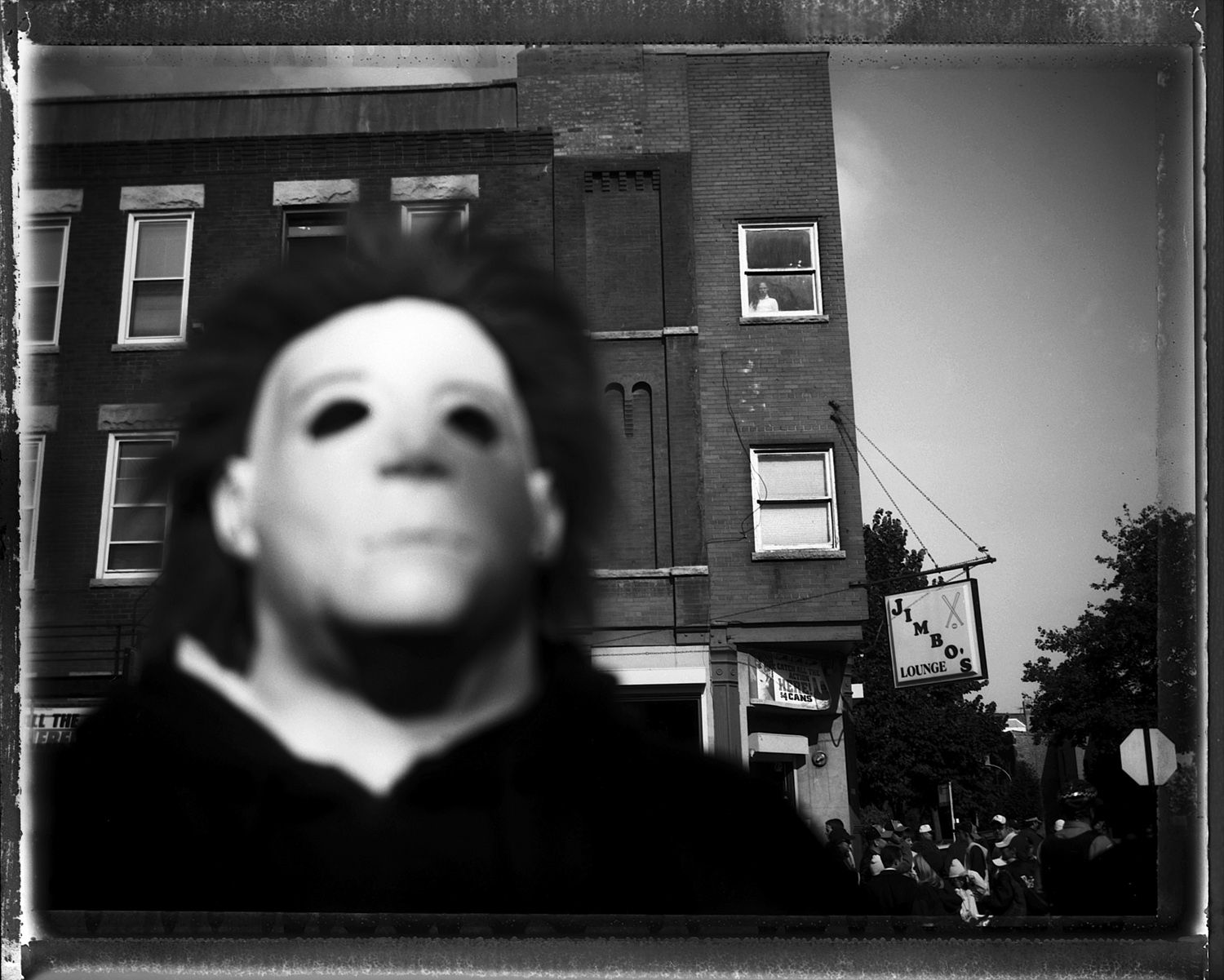 A man poses wearing his mask from the Friday the 13th movies. He stand in front of Jimbo's Bar, which was a local legendary establishment in the Bridgeport neighborhood. Bridgeport, home to Mayor Richard J. Daley, was known as one of the most brutally racist neighborhoods in the city and to this day has resisted integration by African-Americans, although many Asians and Latinos have moved into the neighborhood in the past few years.
