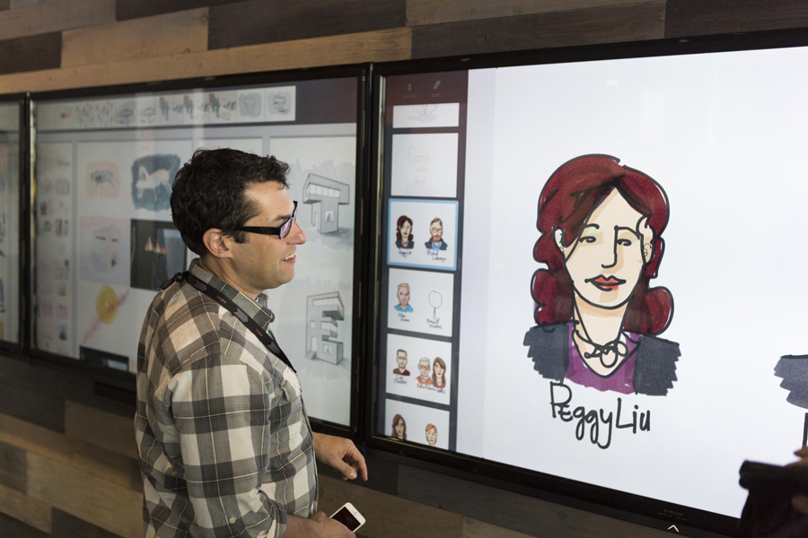 In the Adobe Drawing Lab, a speaker looks at a rendering of speaker Peggy Liu. Photo: Bret Hartman