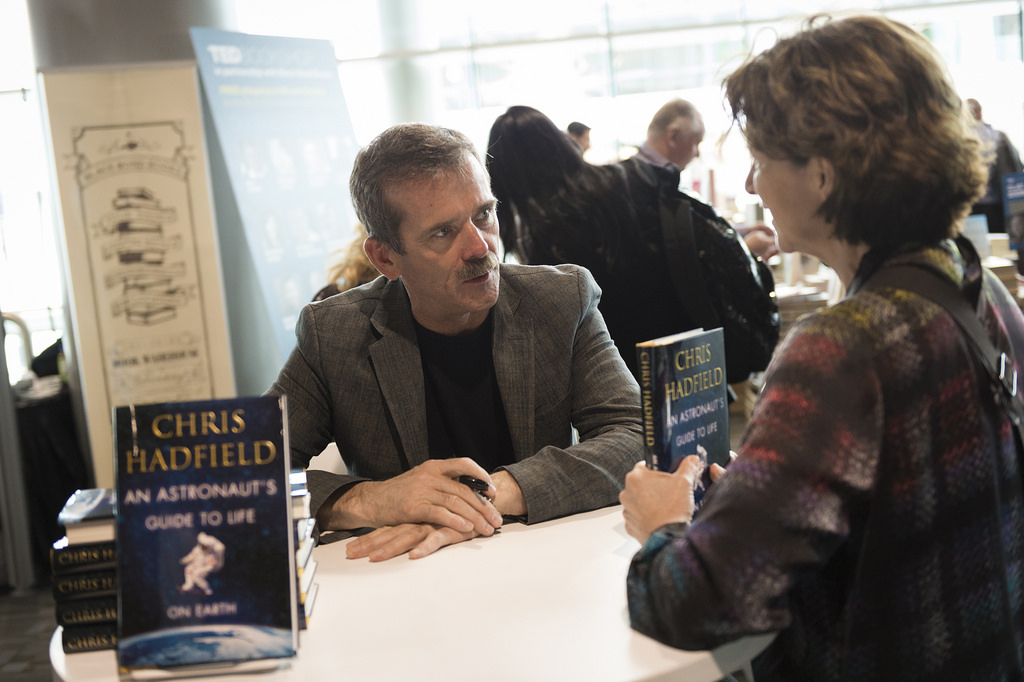Chris Hadfield, whose talk was posted on TED.com today, signs books in the TED Bookstore. Photo: James Duncan Davidson