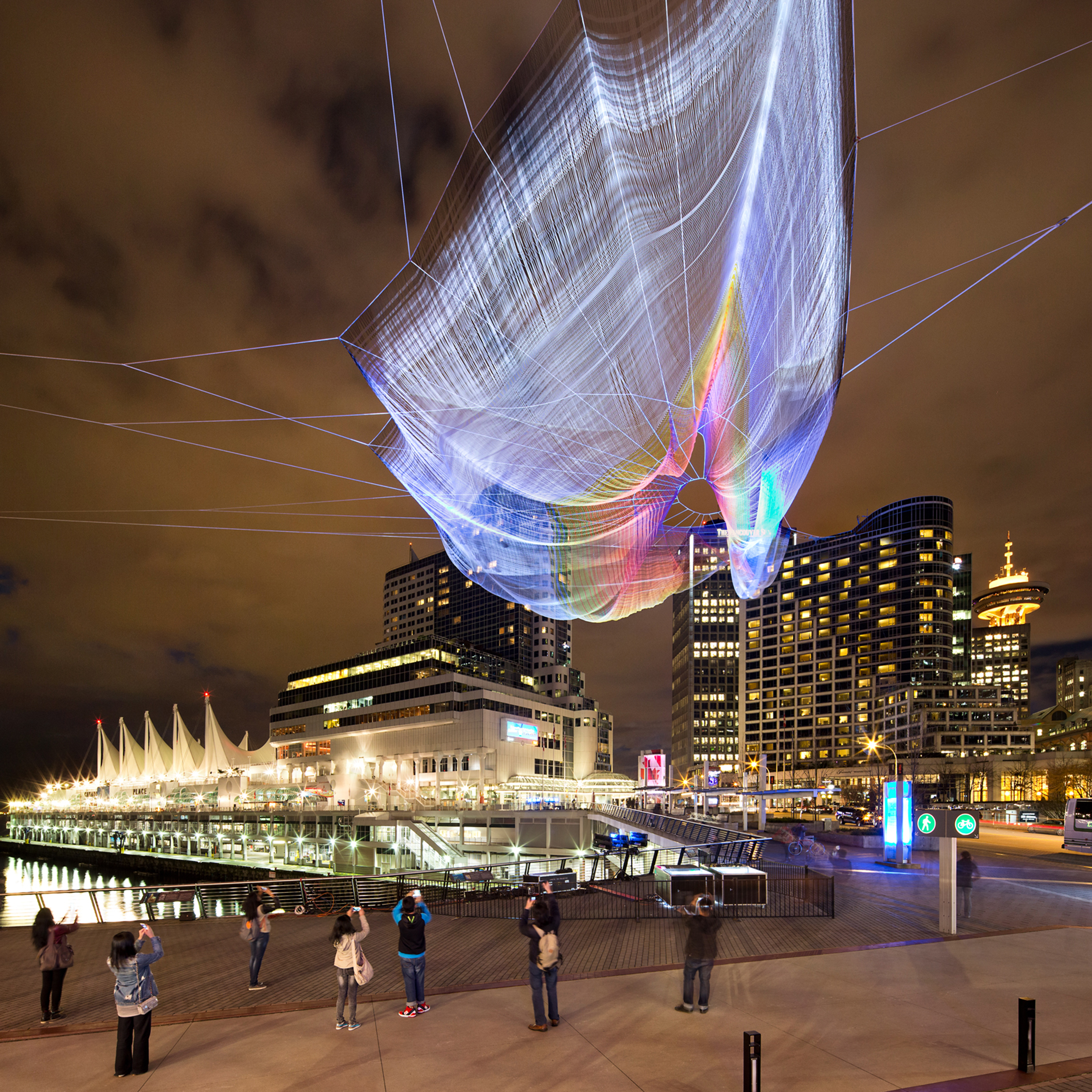 Outside the Vancouver Convention Centre, people gather to interact with Skies Painted with Unnumbered Sparks. Photo: Ema Peter 