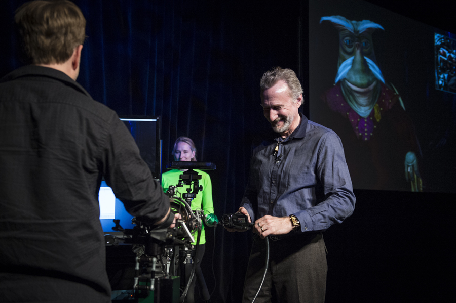 Henson and two puppeteers show how a computer-generated character can be performed. One puppeteer uses the "personal control system" for the voice and face. And a second puppeteer in a green suit controls the body movement. Photo: James Duncan Davidson
