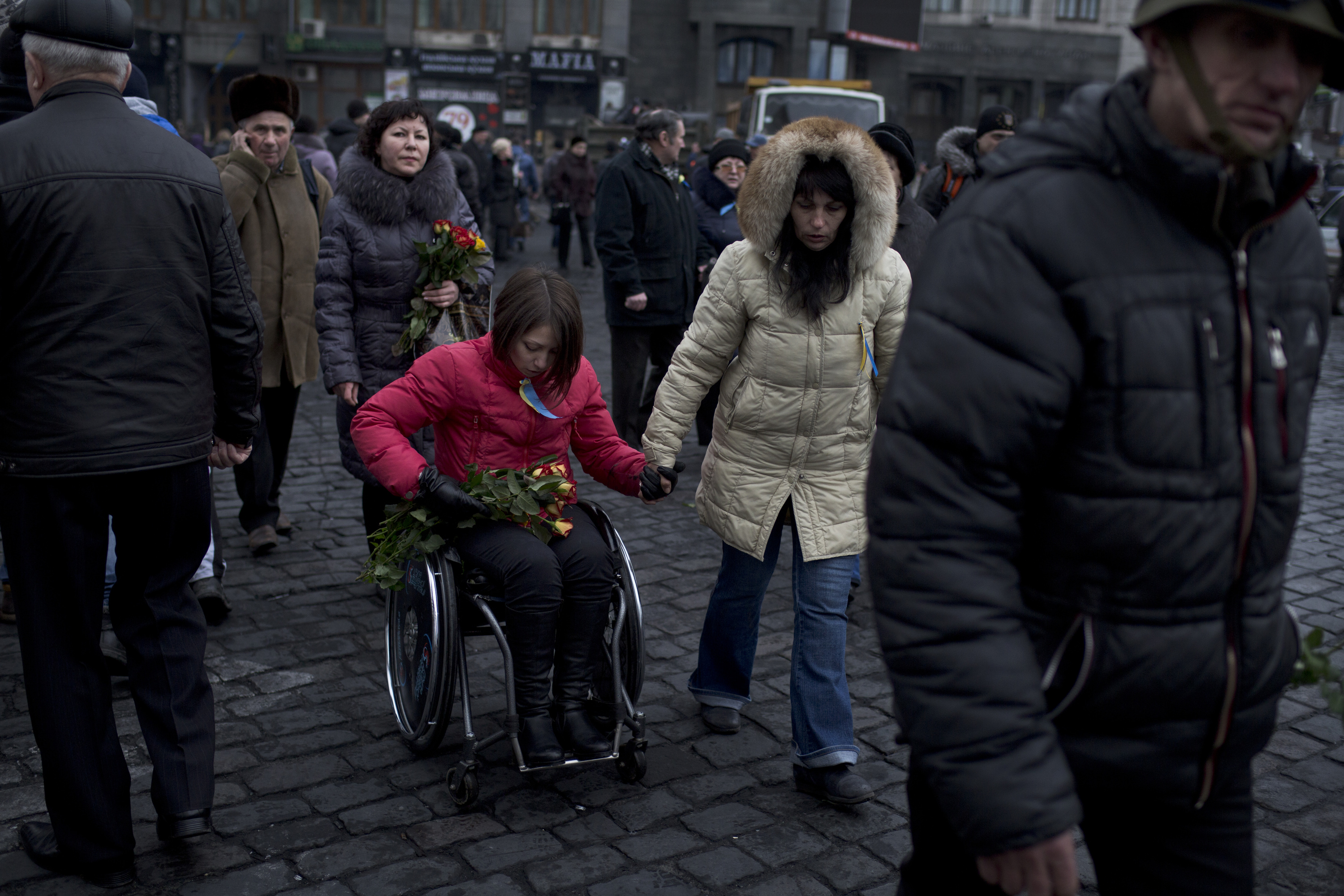Women distribute flowers to anti-government protesters guarding the barricades in Independence Square in Kiev, Ukraine on Feb. 23, 2014. (Ed Ou/Reportage by Getty Images) 