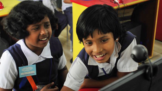 Students at the School in the Cloud in India excitedly figure out how to use a computer. Photo: Courtesy of Jerry Rockwell