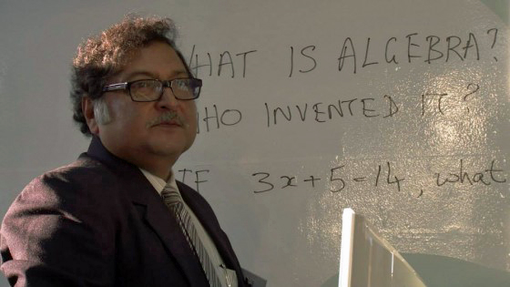 Sugata Mitra watches a group of children as they investigate the question: What is algebra? Photo: Courtesy of Jerry Rockwell 