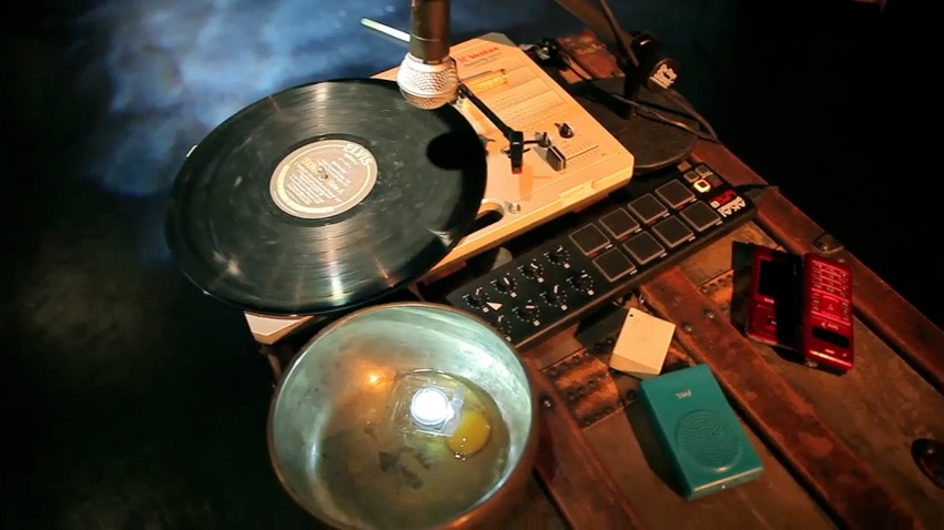 Record player, bowl, egg. A still from the workshop performance of Sunken Cathedral.  Directed by Glynis Rigsby.  Photo: Ash Hsie