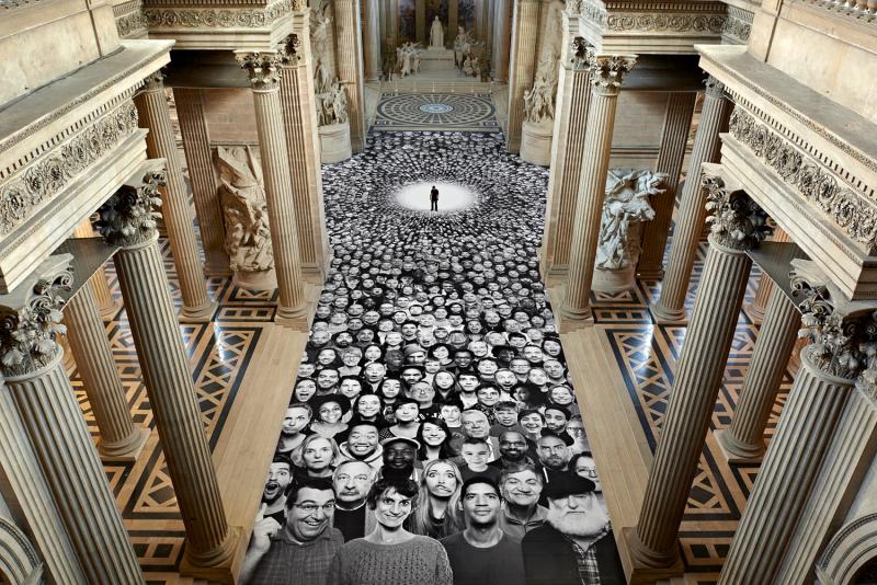 TED Prize winner JR stands in the center of his Panthéon collage. Photo: Inside Out Project