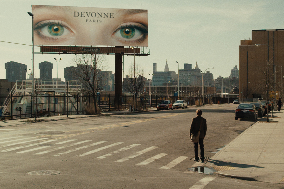 Molecular biologist Ian (aka Michael Pitt) stares at a billboard of a pair of green eyes in Mike Cahill's film "I Origins." Photo: Fox Searchlight