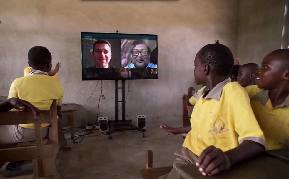 Students at the Pencils of Promise Omega School in Ghana talk to Adam Braun and Sugata Mitra remotely. Photo: Microsoft Work Wonders Project
