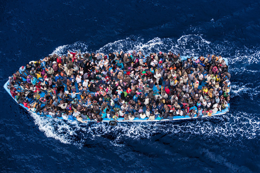 Refugees fleeing by sea / Photo by: Massimo Sestini, Italian Navy