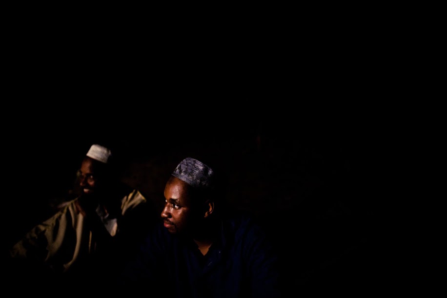 Muslims living in the woods of South Carolina sit together and share stories after they break their Ramadan fast. All of them have become acclimated to the stark darkness of the night. Image: 30 Mosques in 30 Days 