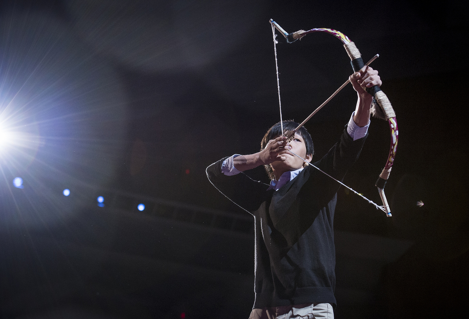 When Dong Woo Jang was giving his talk at TED2013, I knew I had less than a split second to capture the shot I wanted. So well before he demonstrated his bow, I found the angle I wanted, engaged my camera’s high-speed burst mode, and waited for him to casually pick up the bow, turn, aim at his target, and fire. It happened so fast that even at nine frames a second, there’s this frame, and then the next where the arrow is leaving the bow. Nothing more. Photo: James Duncan Davidson/TED