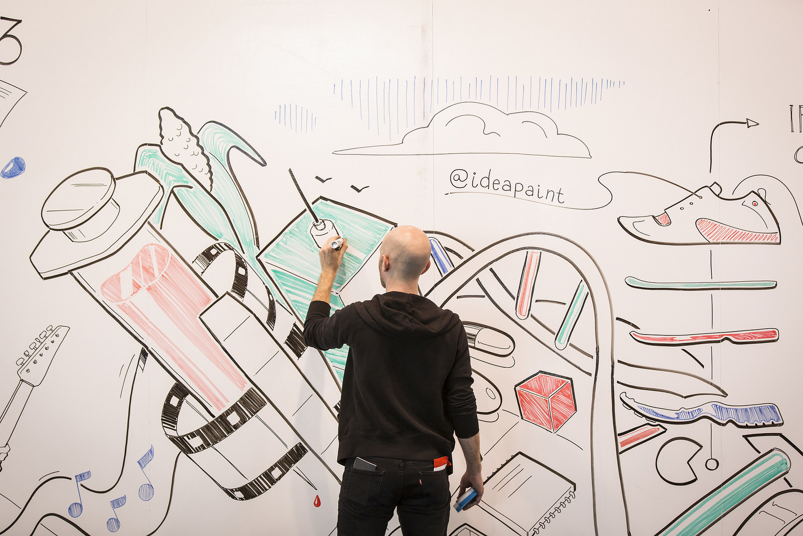 Artist Derek Cascio colors on the walls of the Vancouver Convention Center, thanks to IdeaPaint—which turns any wall into a dry erase board. Photo: Ryan Lash/TED
