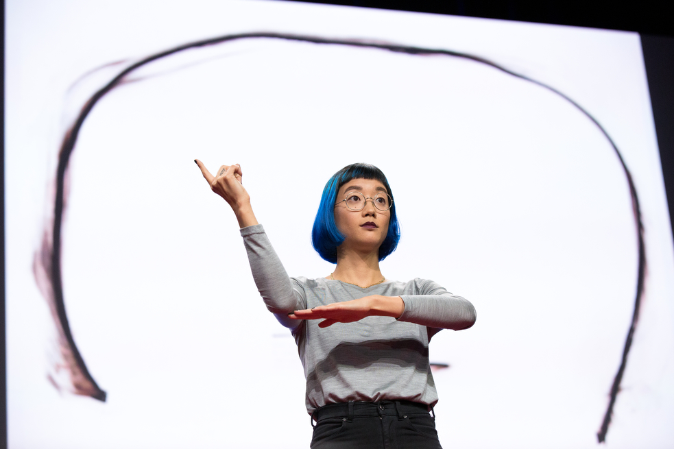 Christine Sun Kim is deaf — but makes sound and language the center of her art. In her talk, she got the audience signing words and concepts to show them the lyric qualities of sign language. Photo: Ryan Lash/TED