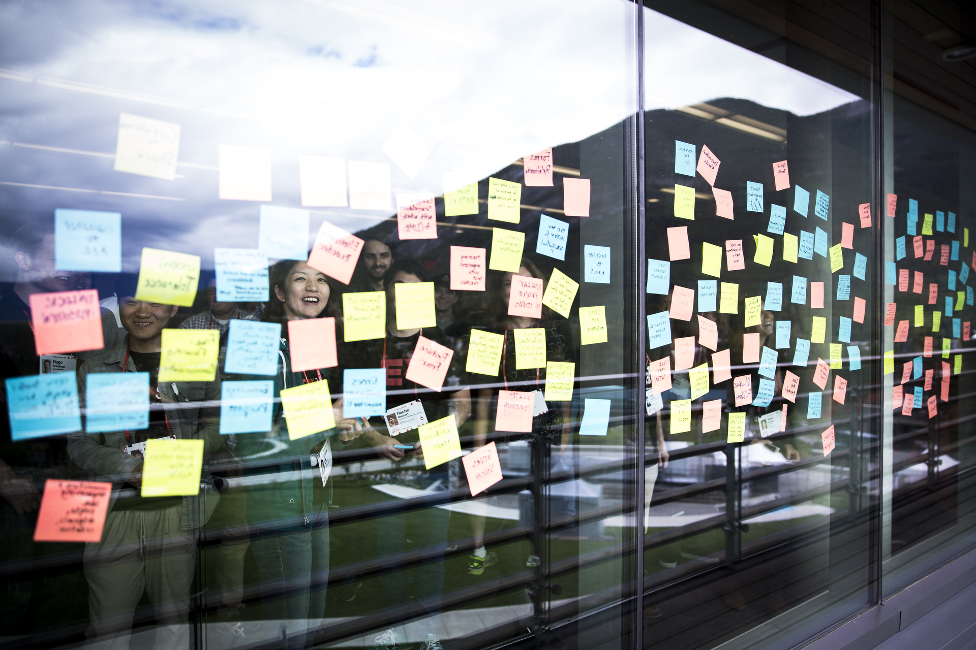Post-it notes on a windo reflect the mountains of Banff outside, in a scene from the TEDx Global Forum meeting at TEDSummit 2016, June 25, 2016, Banff, Canada. Photo: Marla Aufmuth / TED