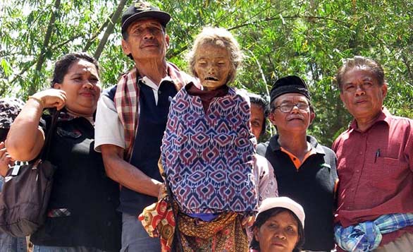 During Kelli Swazey's TED Talk, she shows a slide of a Torajan family with their deceased relative.