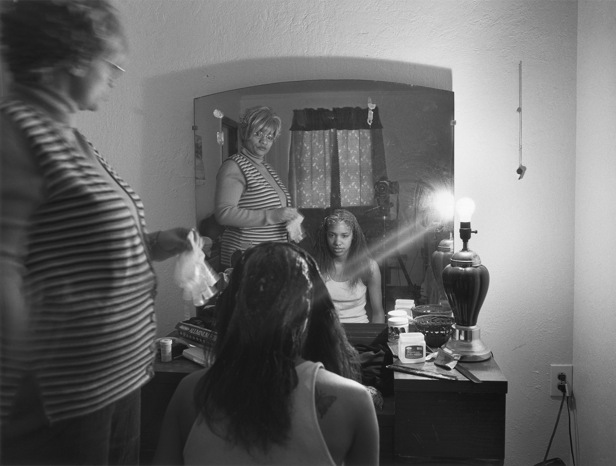 “For the past 12 years, my mother and I have made collaborative portraits together, disrupting the idea that the privileged photographer comes from the outside.” Mom Relaxing My Hair 2005, from "The Notion of Family" (Aperture 2014).
